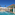 Luxury resort pool with swim-up bar, green tiles, and palm trees.