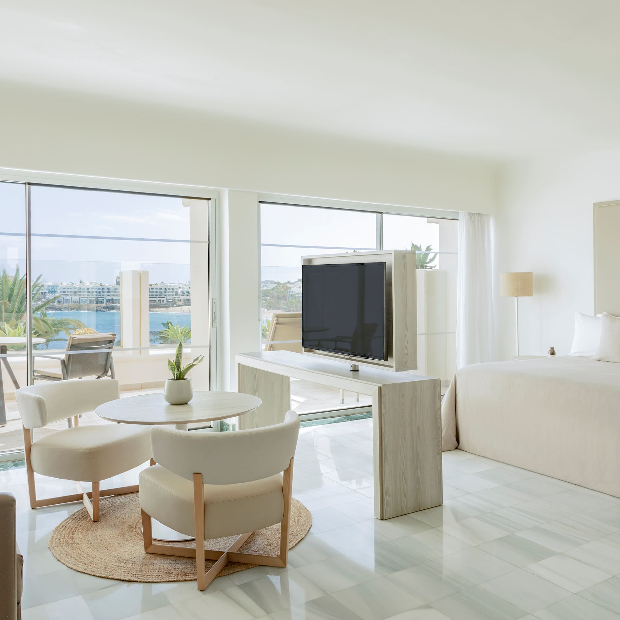 a room with a bed and a television