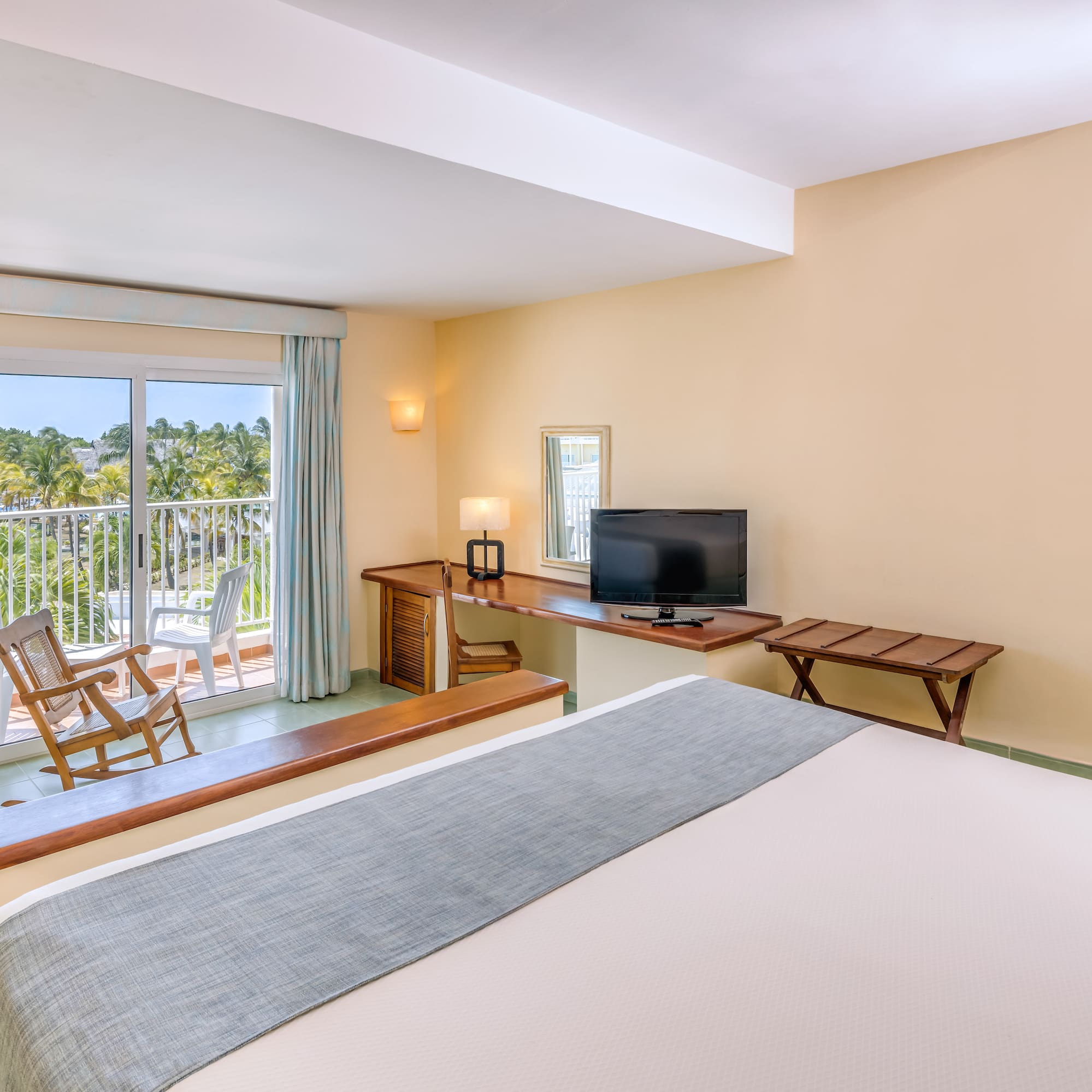 a room with a bed and a television