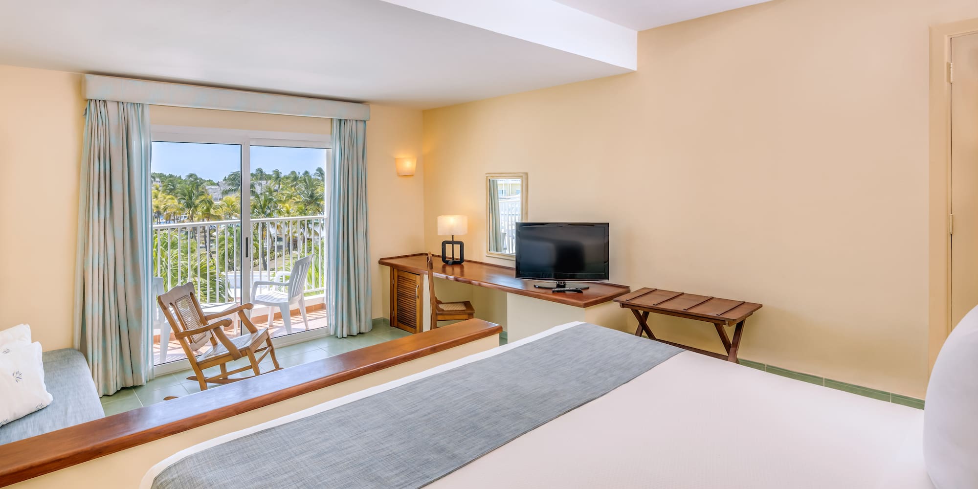 a room with a bed and a television