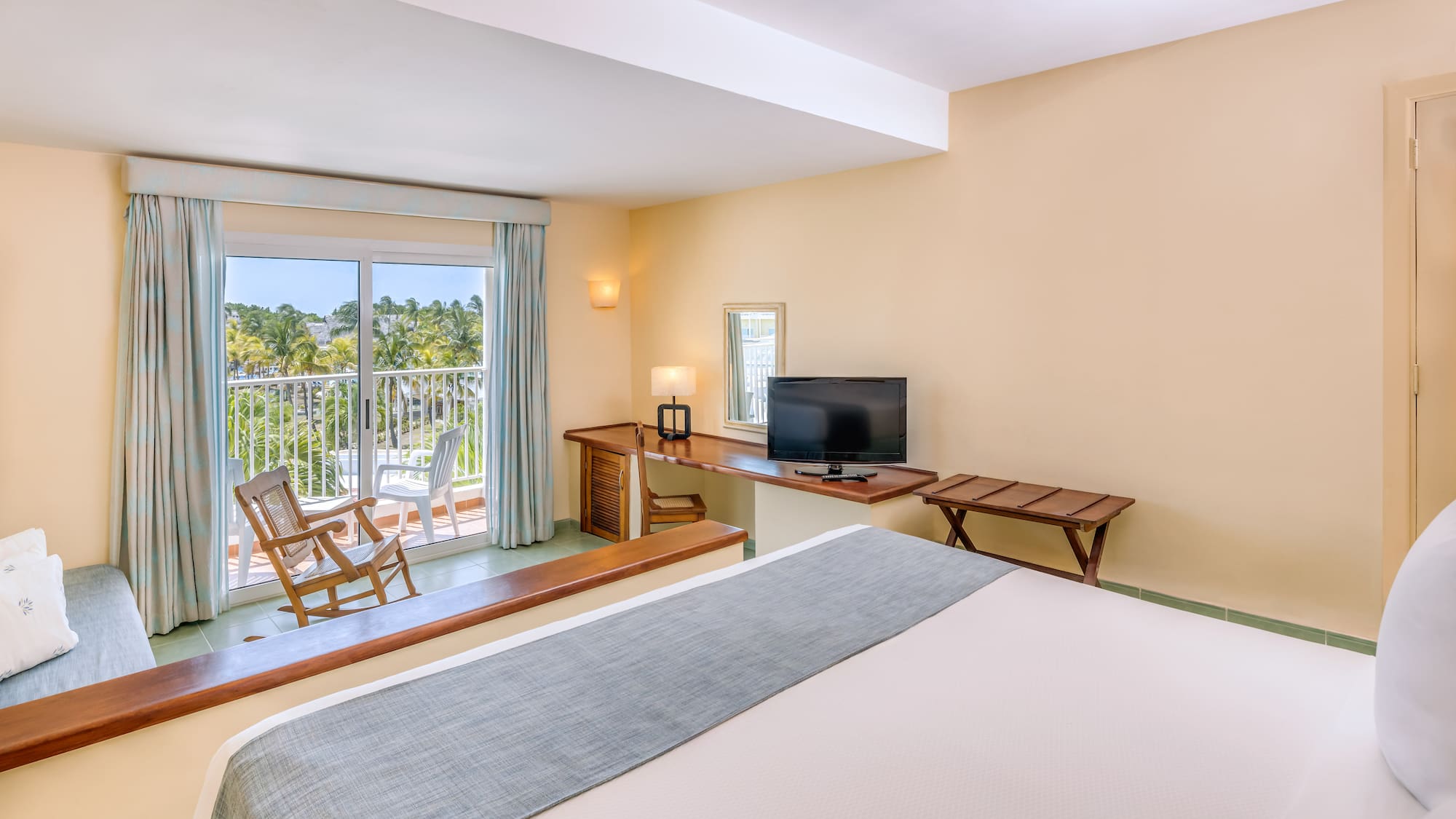 a room with a bed and a television