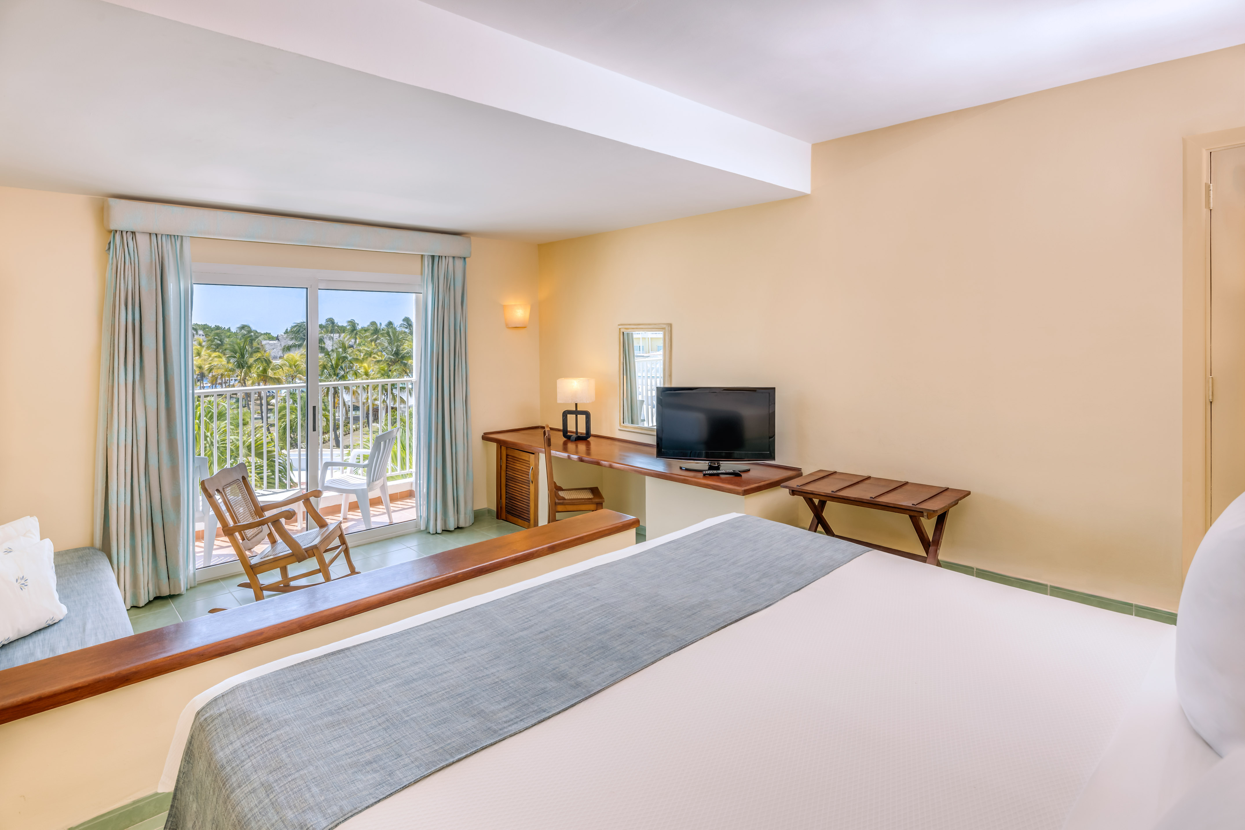 a room with a bed and a television