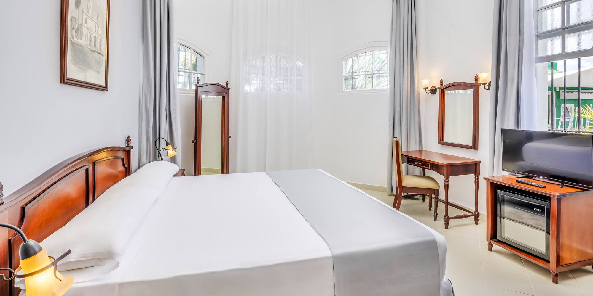 a room with a bed and a desk