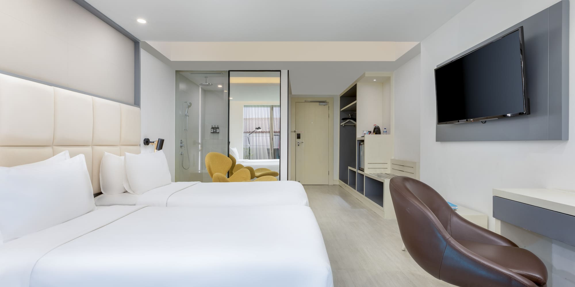 a room with two beds and a tv