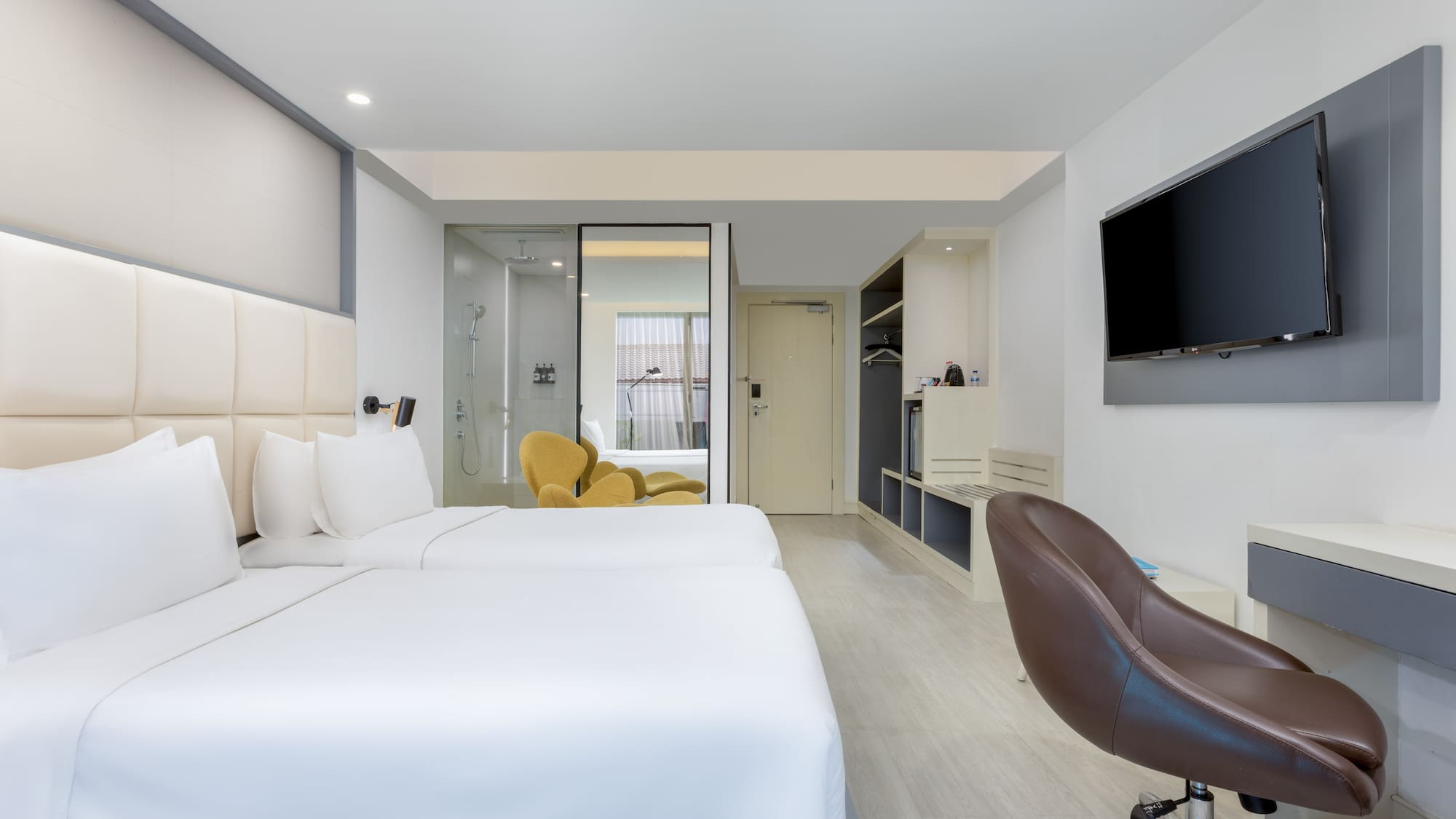 a room with two beds and a tv