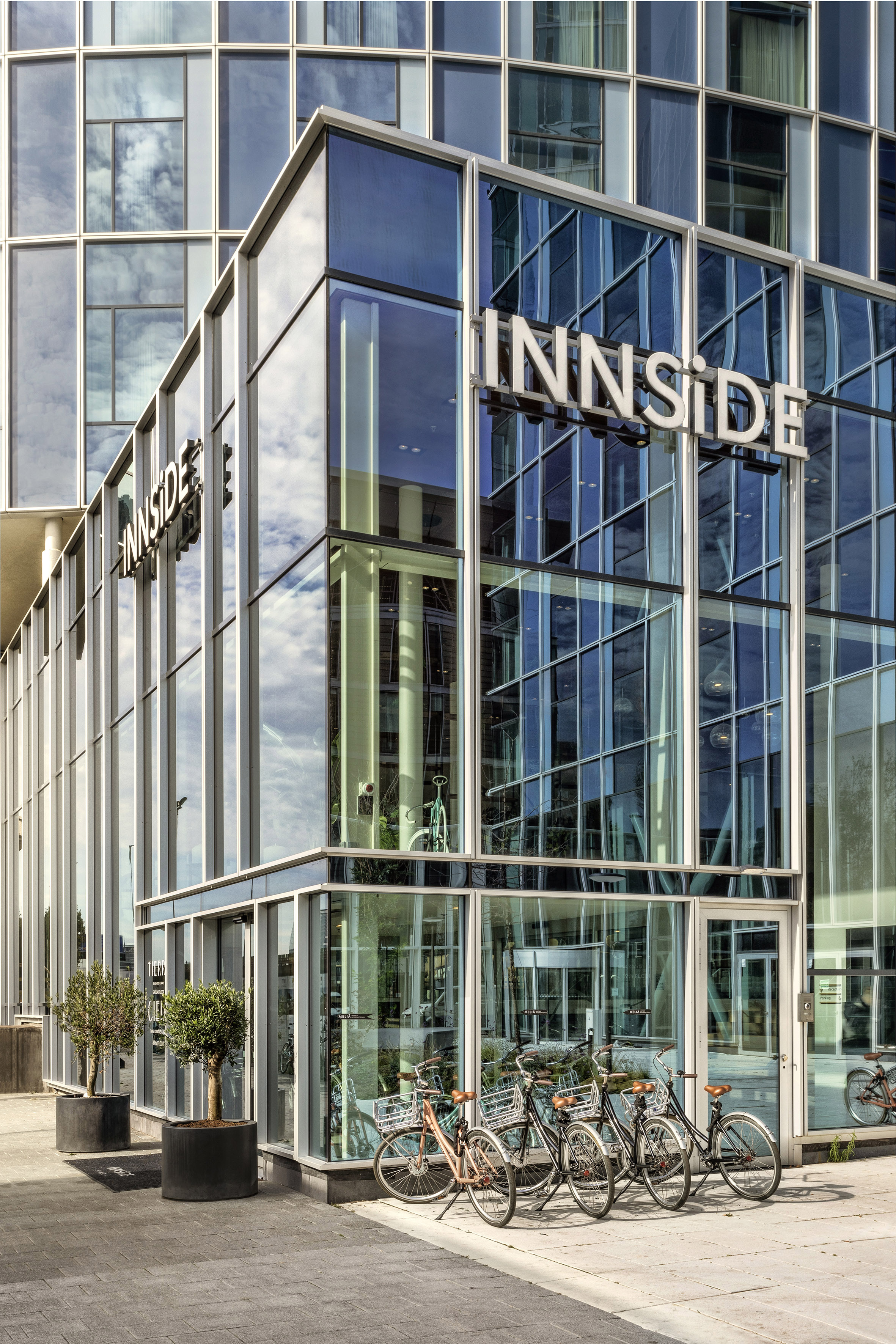 a glass building with a bike parked in front of it