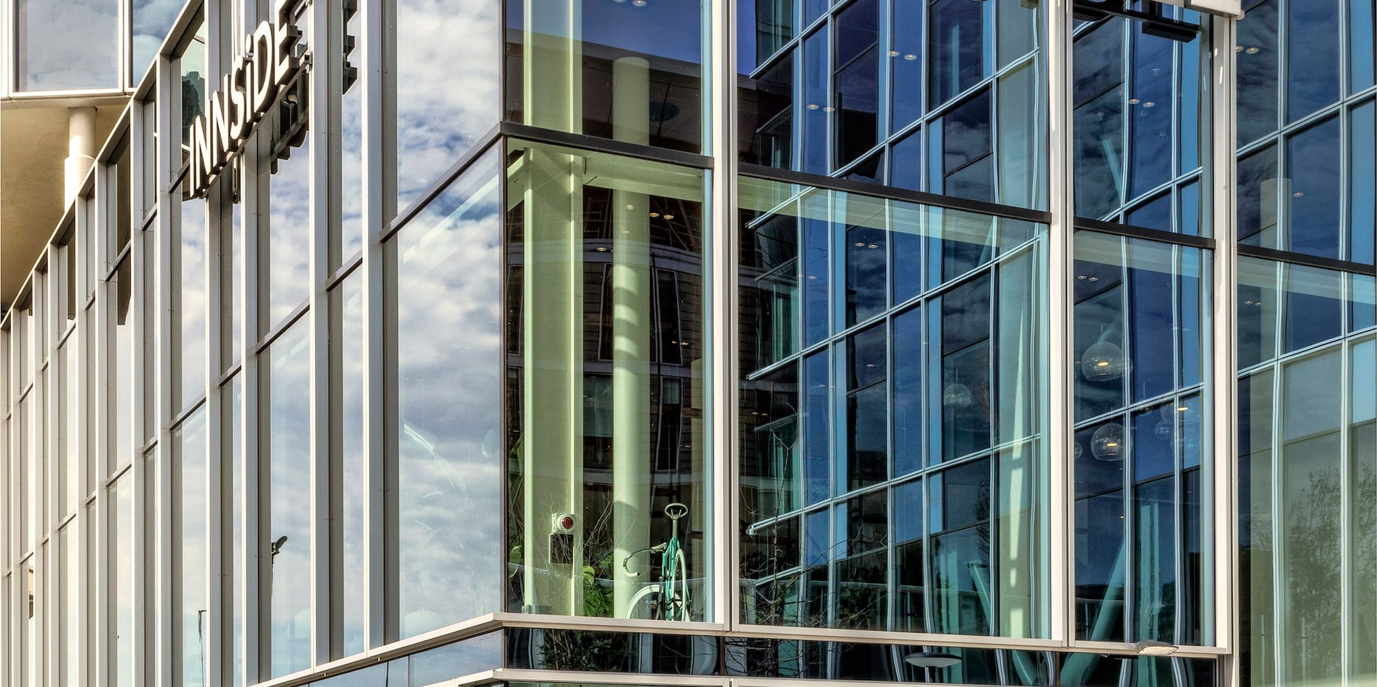 a glass building with a bike parked in front of it