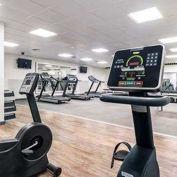 a room with treadmills and a screen