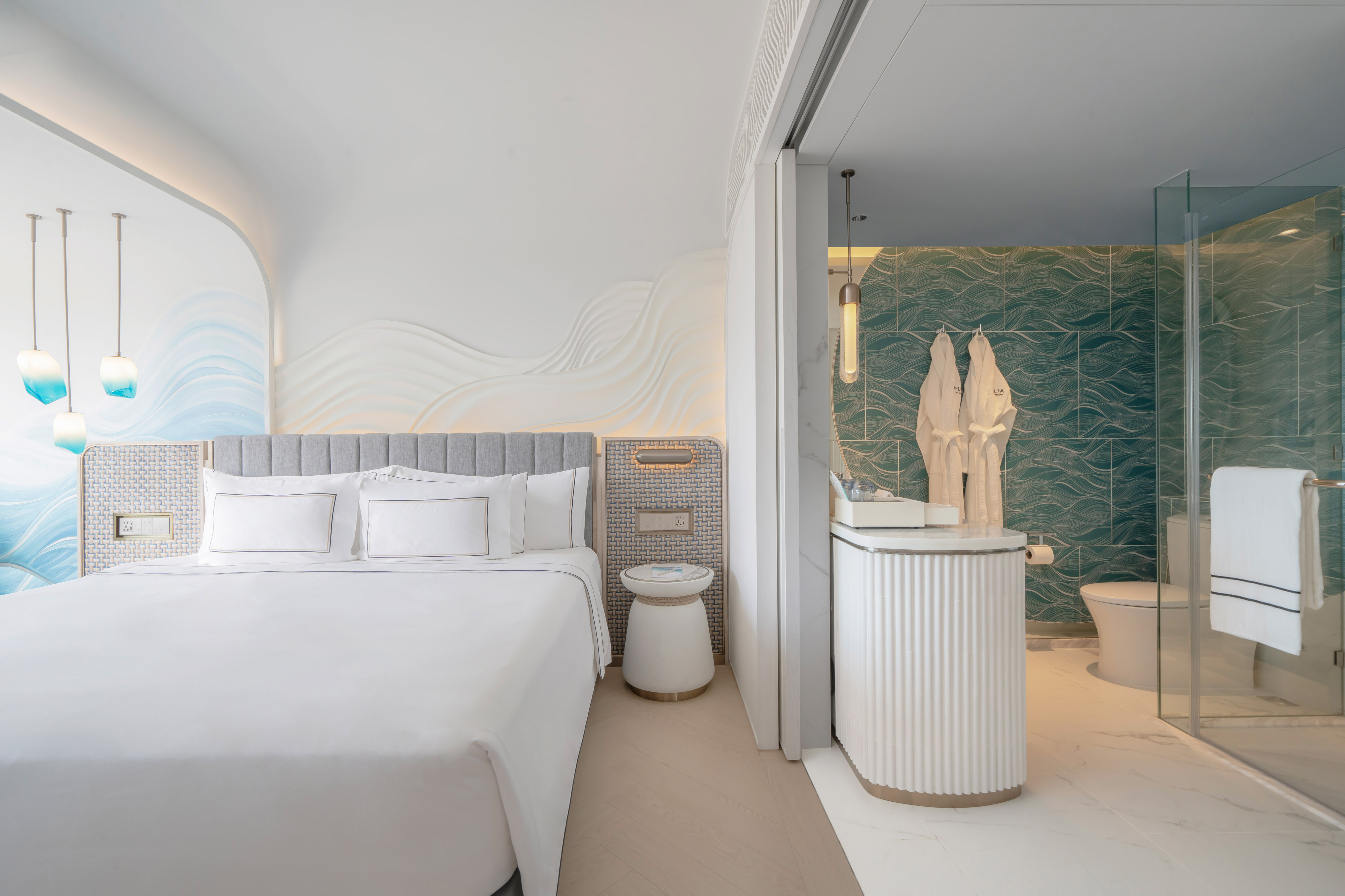 Contemporary hotel room with wave design, white bed, and open bathroom. - Deluxe hướng biển - Meliá Pattaya Hotel, Pattaya