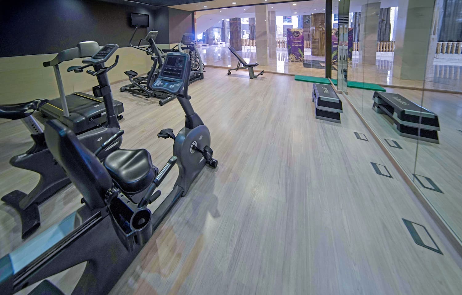 a room with exercise bikes and a glass wall