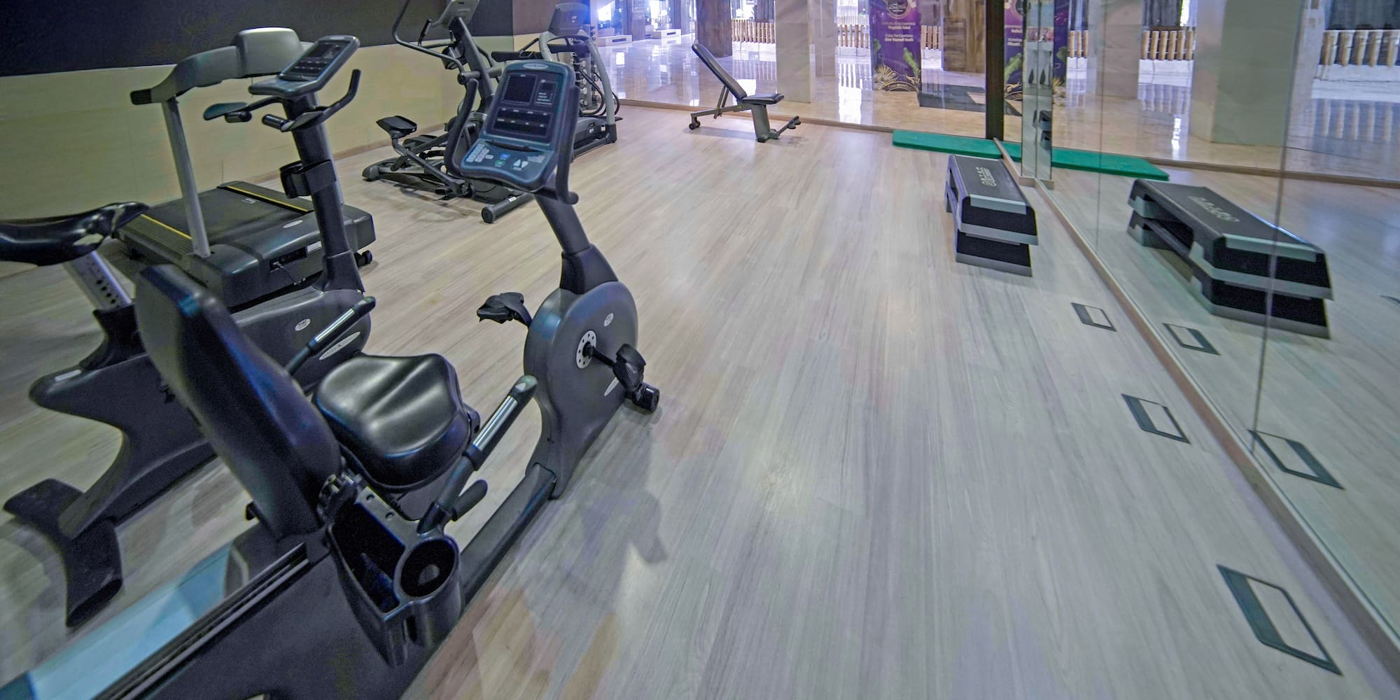a room with exercise bikes and a glass wall