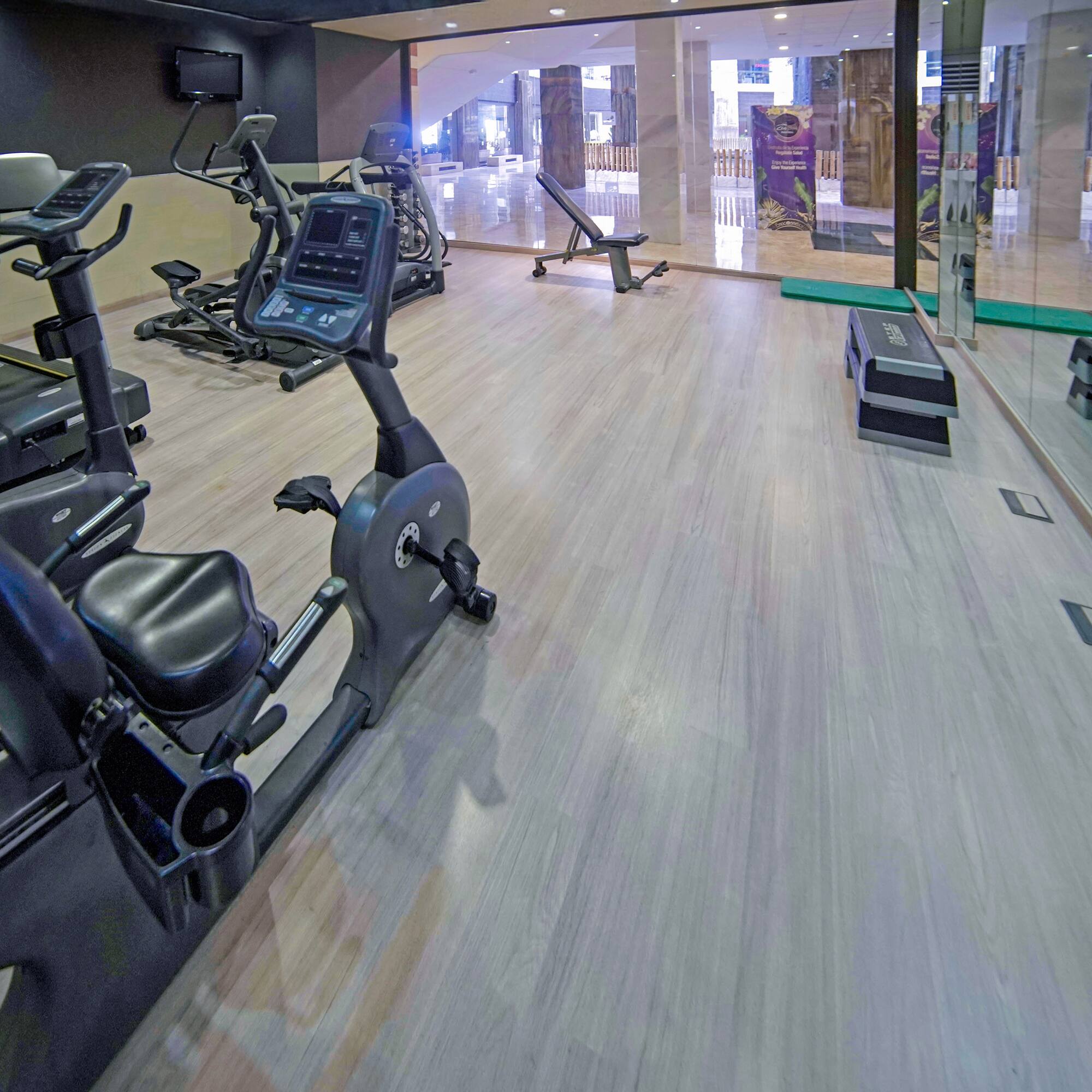 a room with exercise bikes and a glass wall