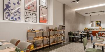 a room with a table and chairs and art on the wall