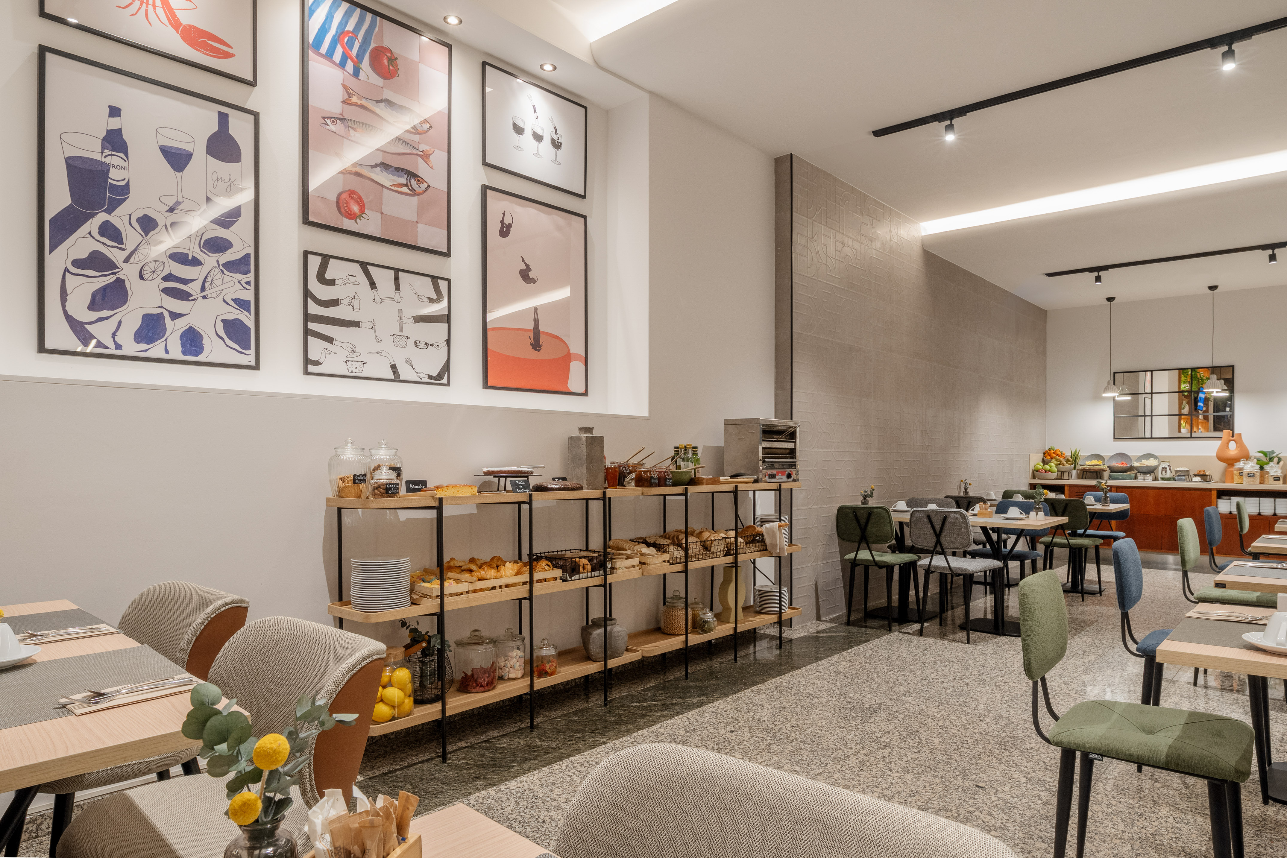 Hotel breakfast buffet with pastries, cereals, and modern dining area.