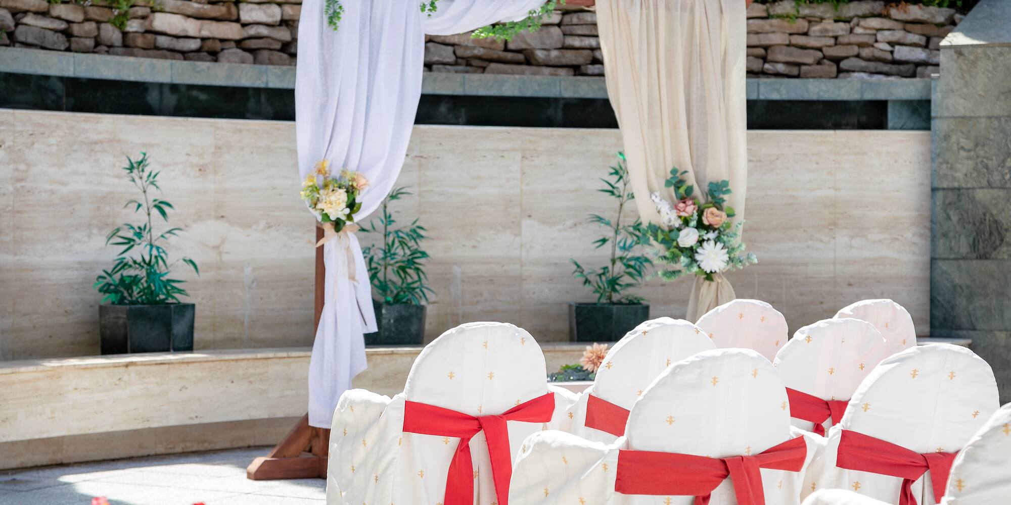 chairs with white chairs and red bows