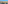 Aerial city view: residential buildings, streets, distant skyline, bright blue sky.