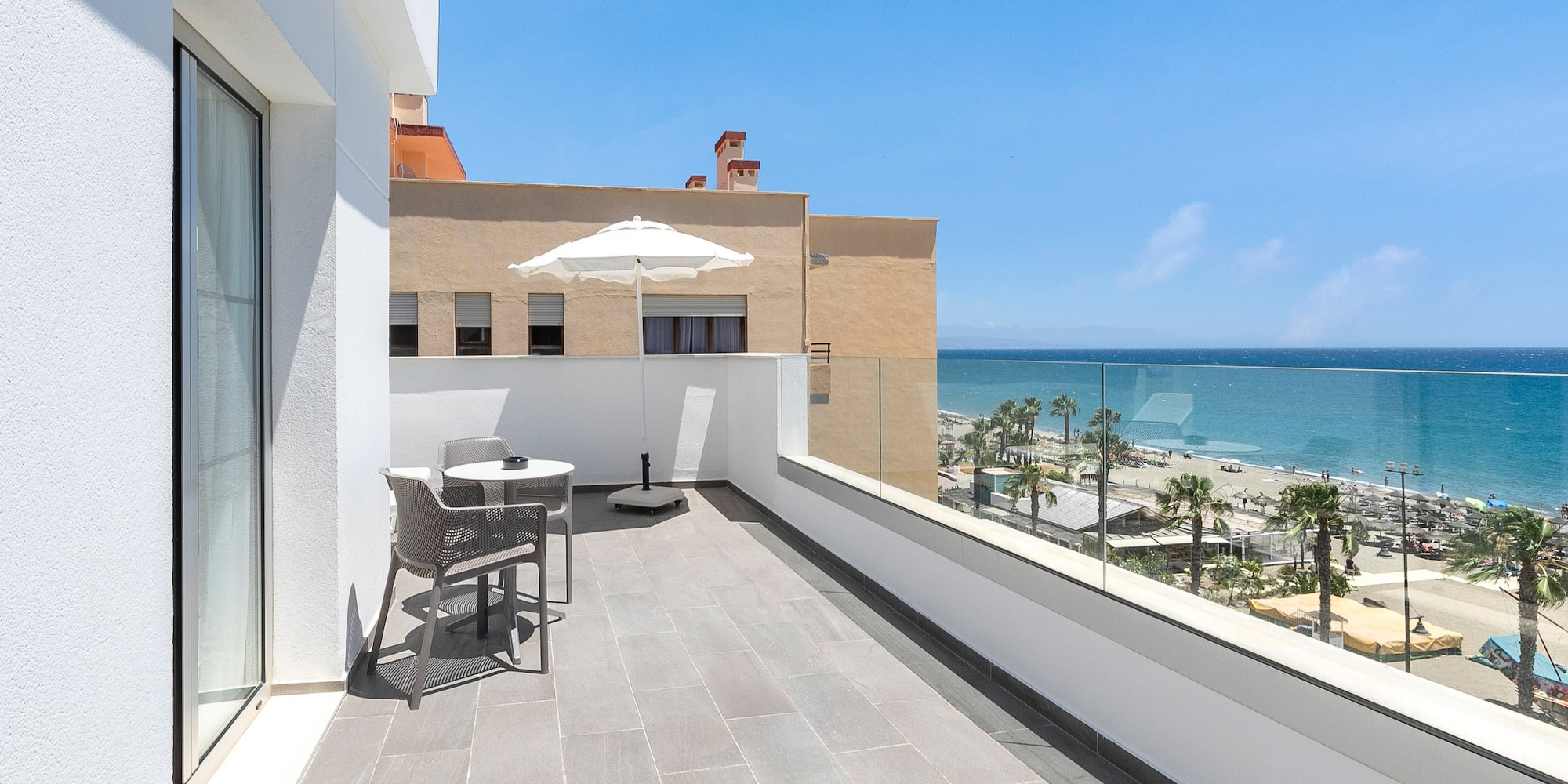 a balcony with a view of the ocean and a beach