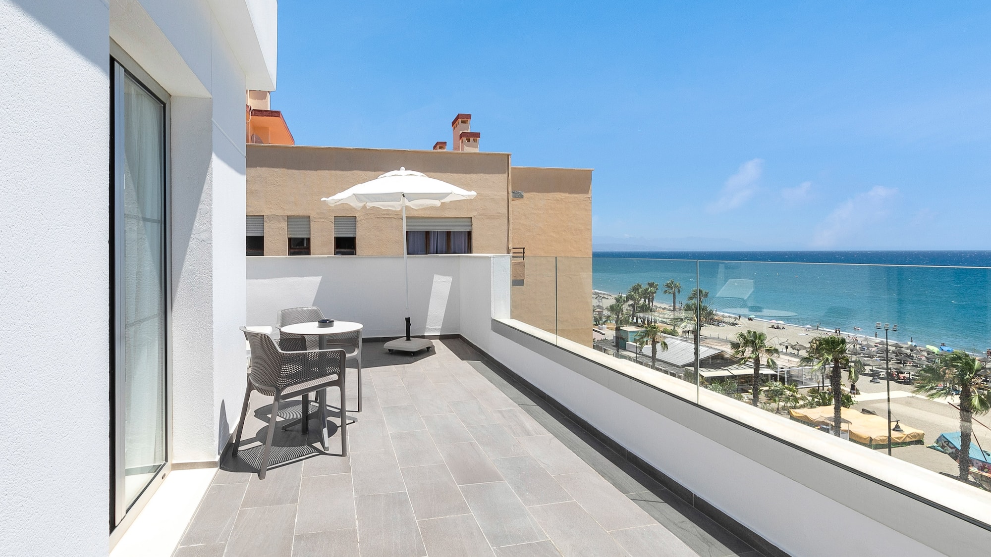 a balcony with a view of the ocean and a beach