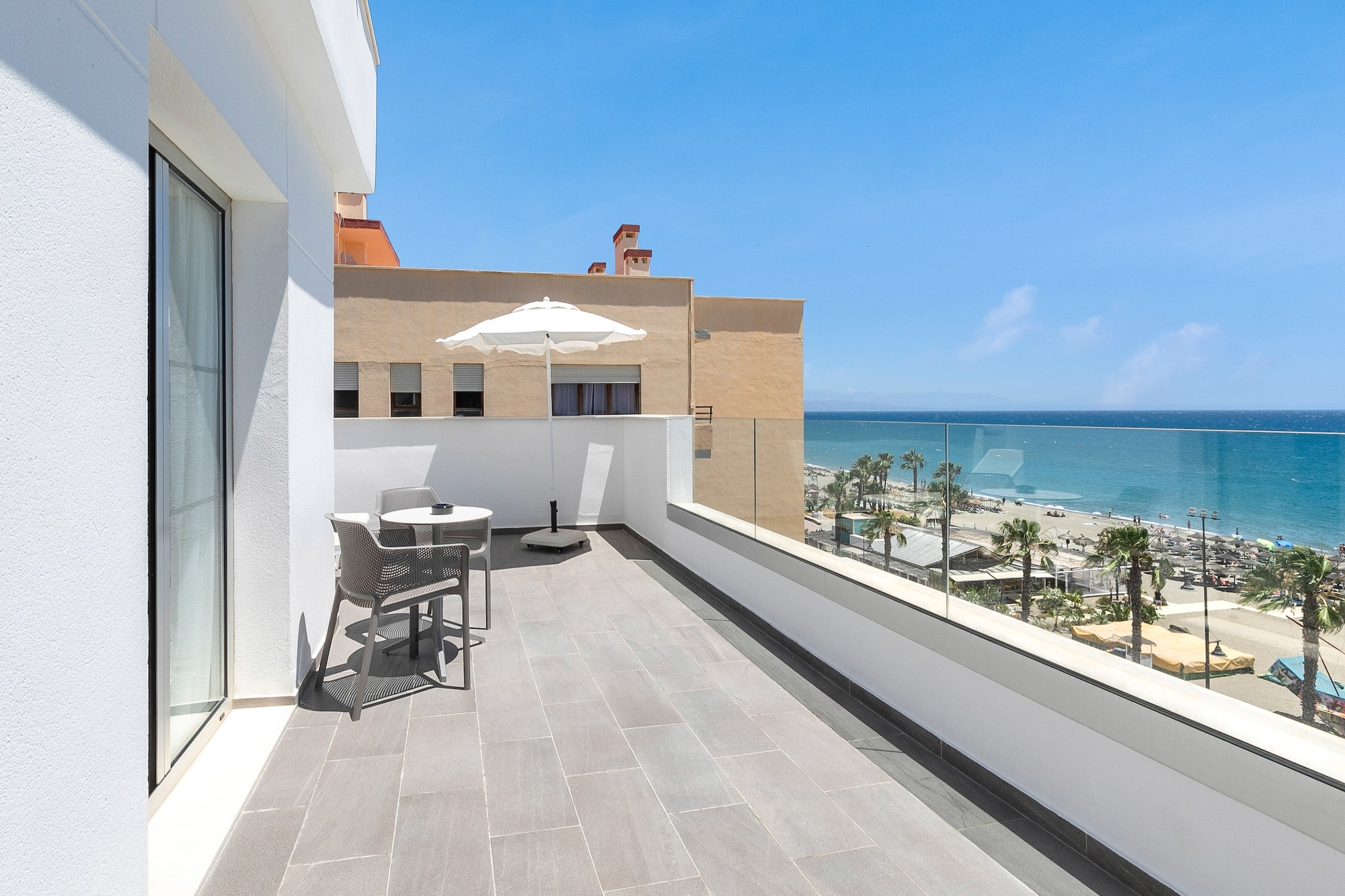 a balcony with a view of the ocean and a beach