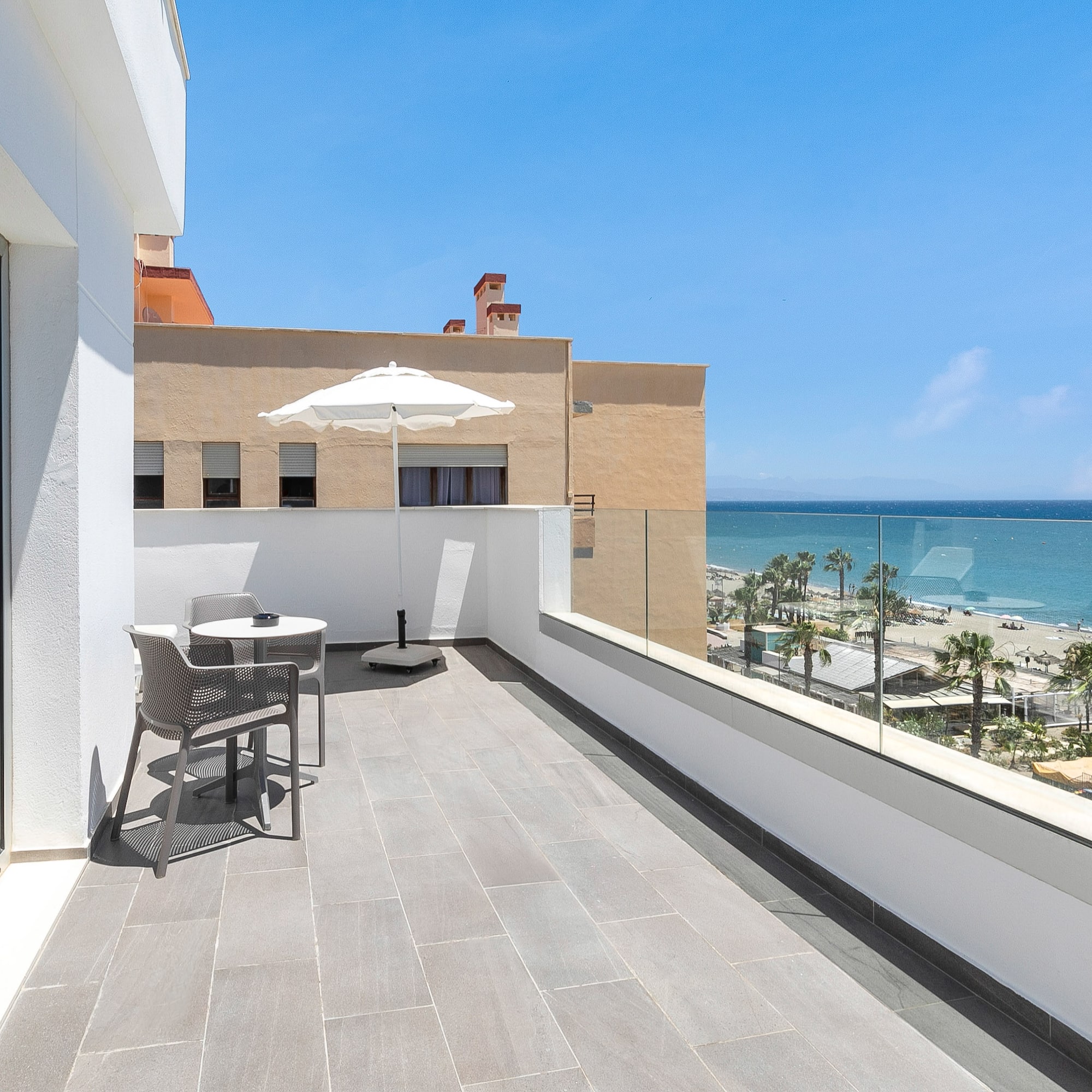 a balcony with a view of the ocean and a beach