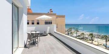 a balcony with a view of the ocean and a beach