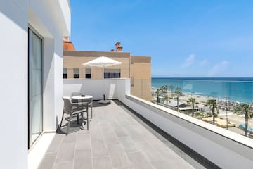 a balcony with a view of the ocean and a beach