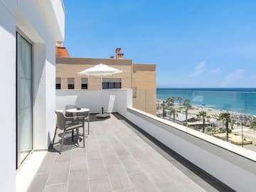 a balcony with a view of the ocean and a beach