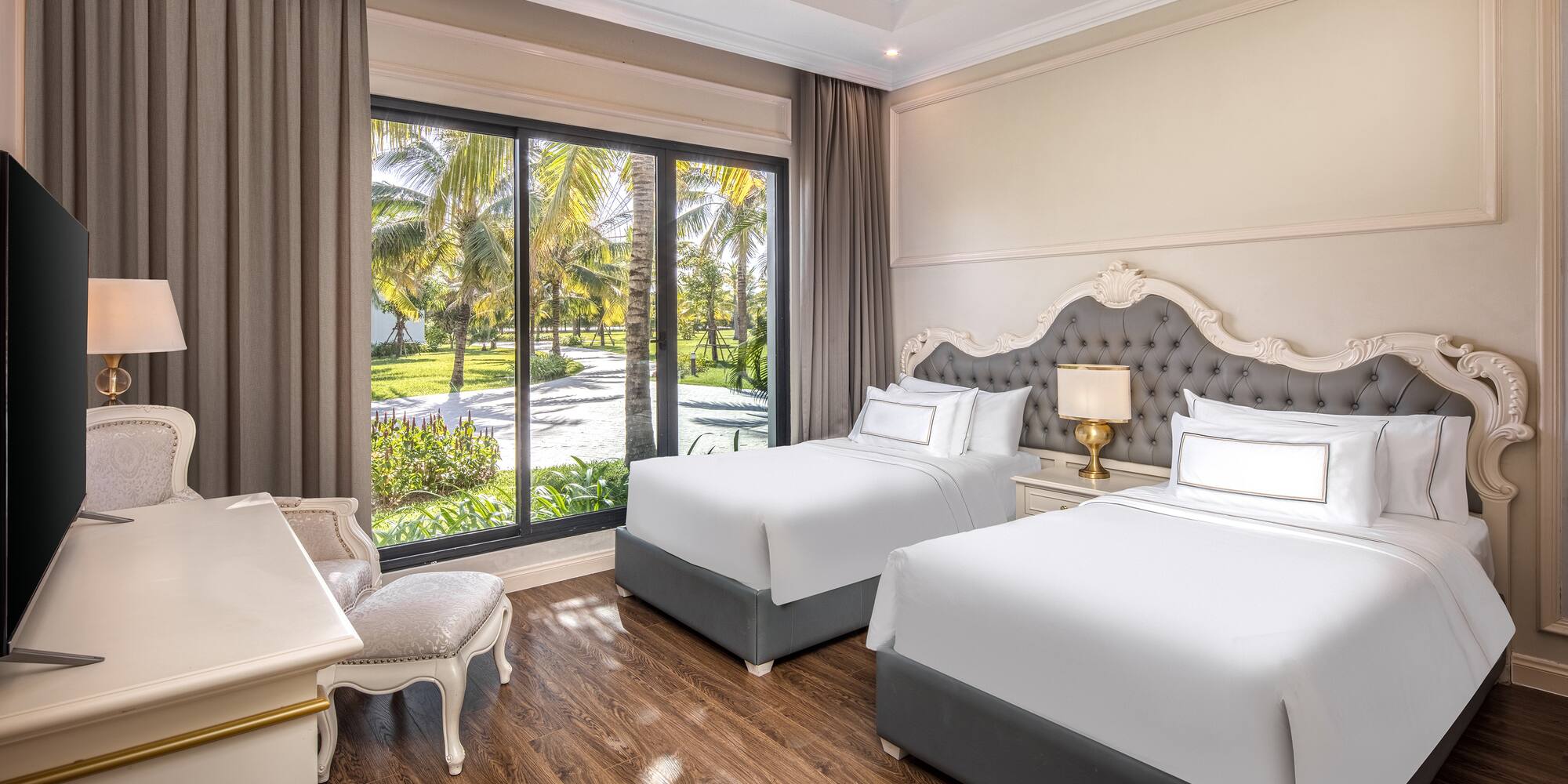 a room with two beds and a desk