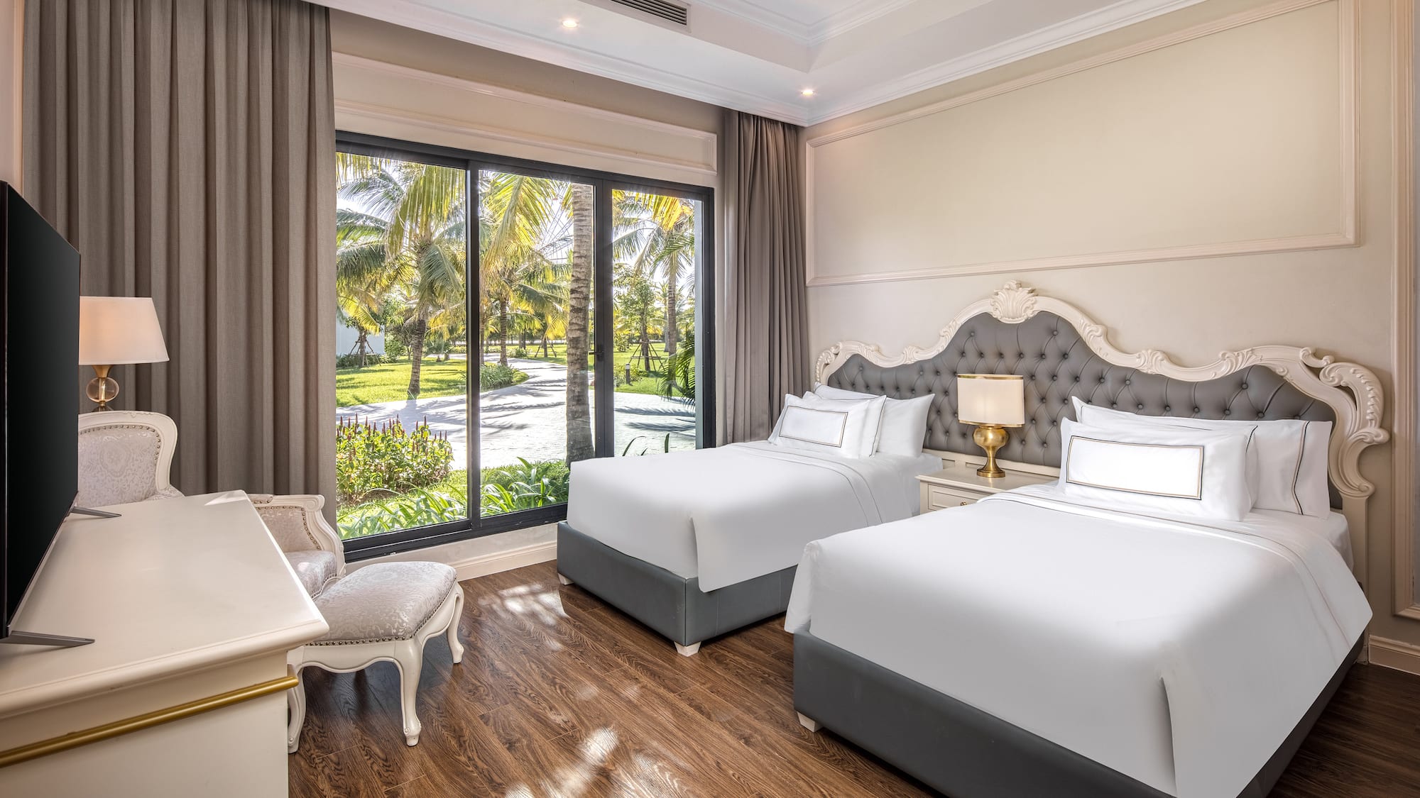 a room with two beds and a desk