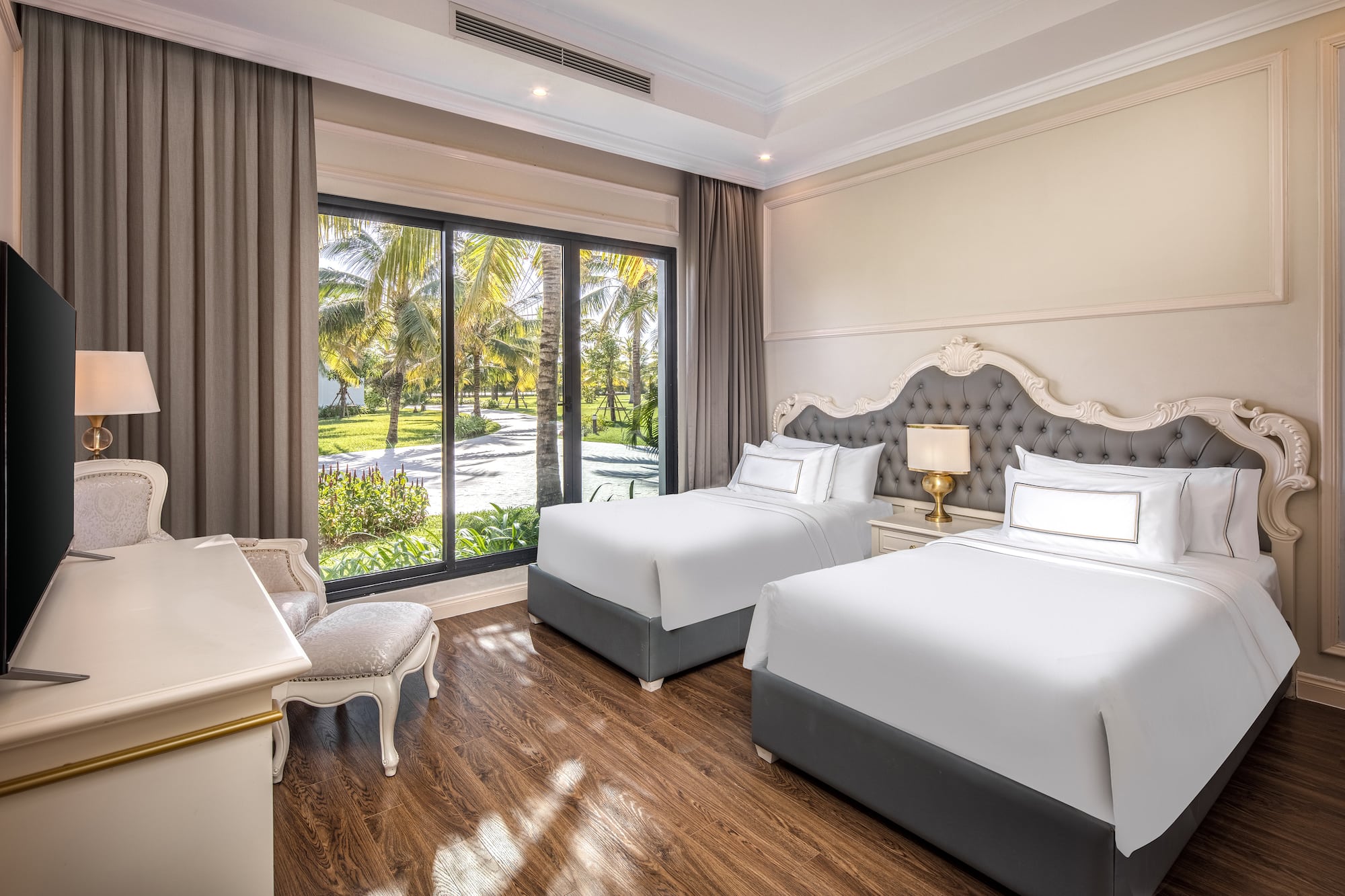 a room with two beds and a desk