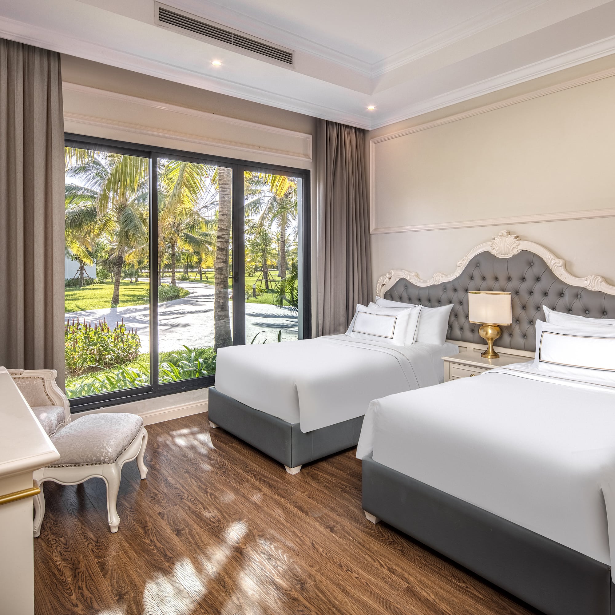 a room with two beds and a desk