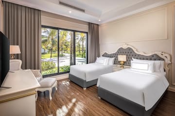 a room with two beds and a desk