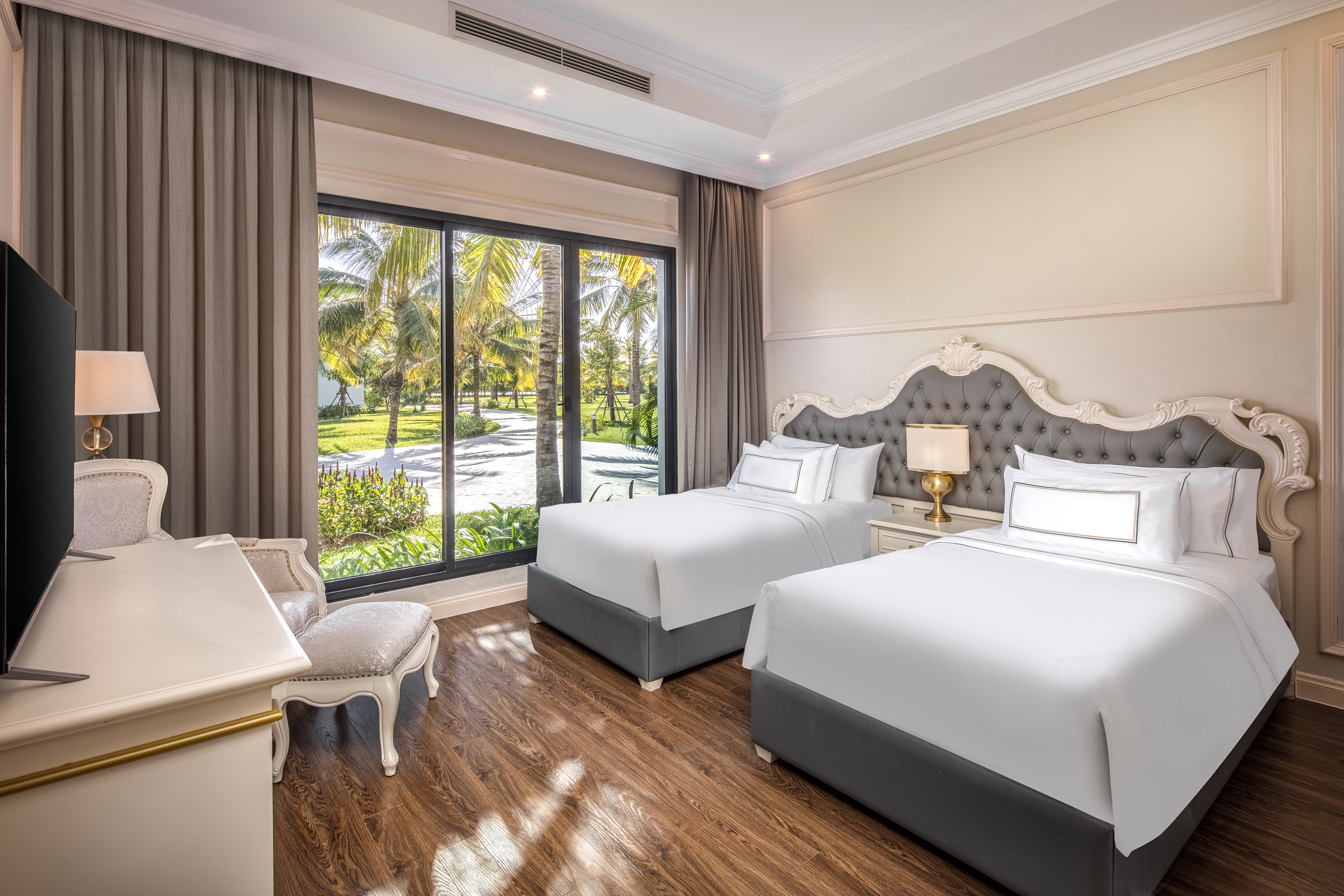 a room with two beds and a desk