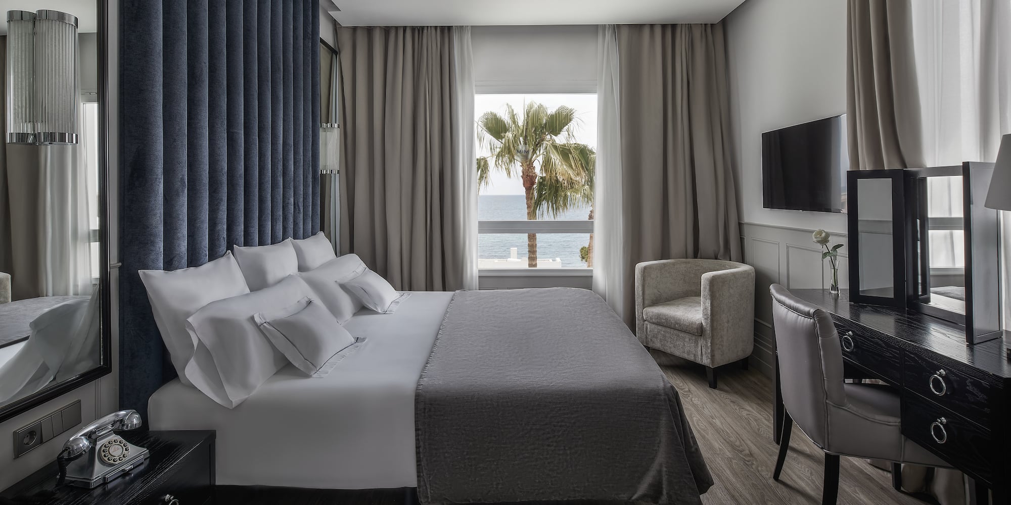 a room with a bed and a television