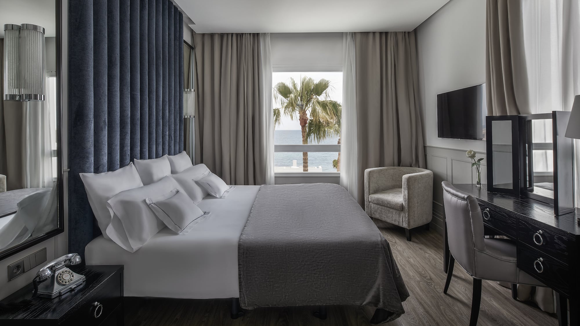 a room with a bed and a television