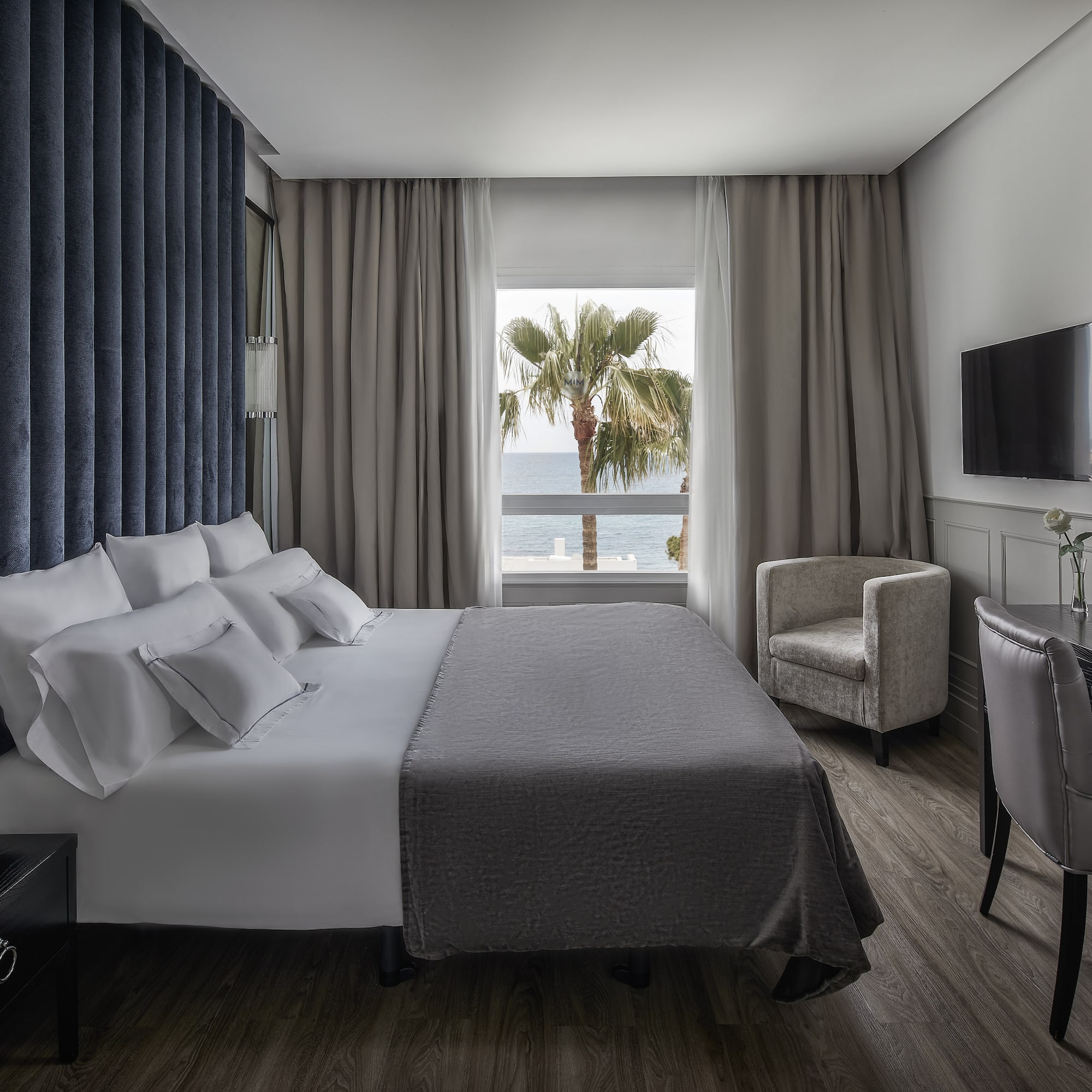 a room with a bed and a television