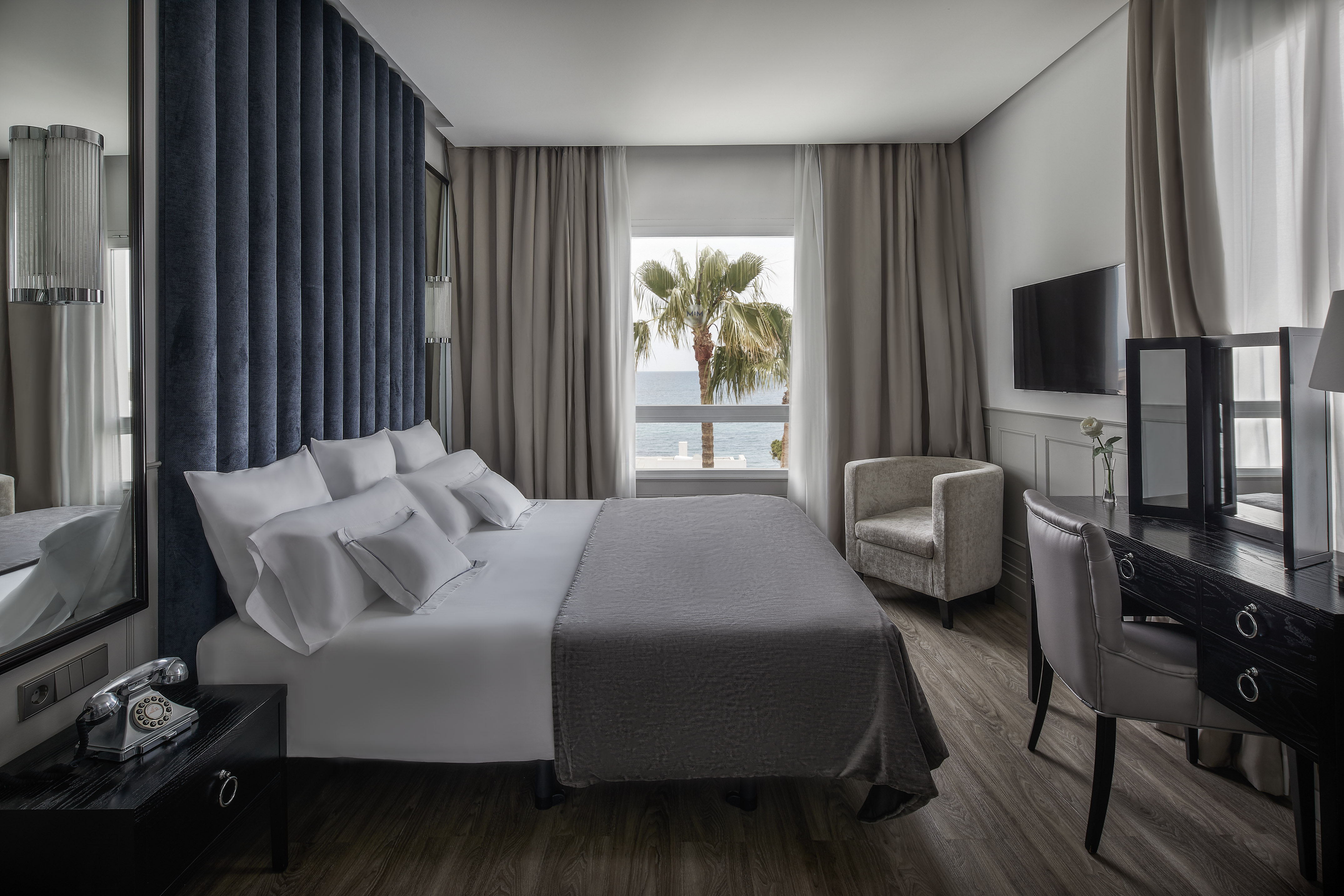a room with a bed and a television