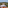 Wine and cheese on a balcony overlooking Tuscan olive groves and a villa.