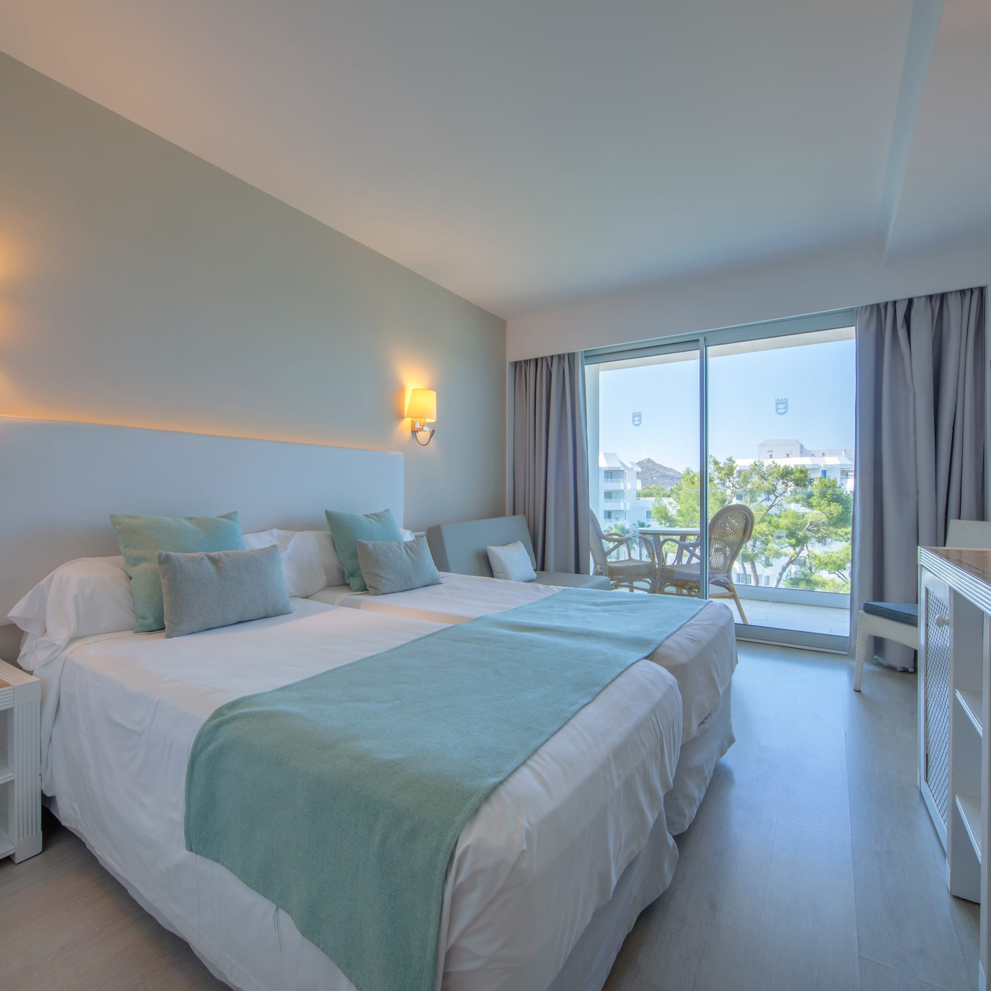 a bedroom with a large bed and a glass door