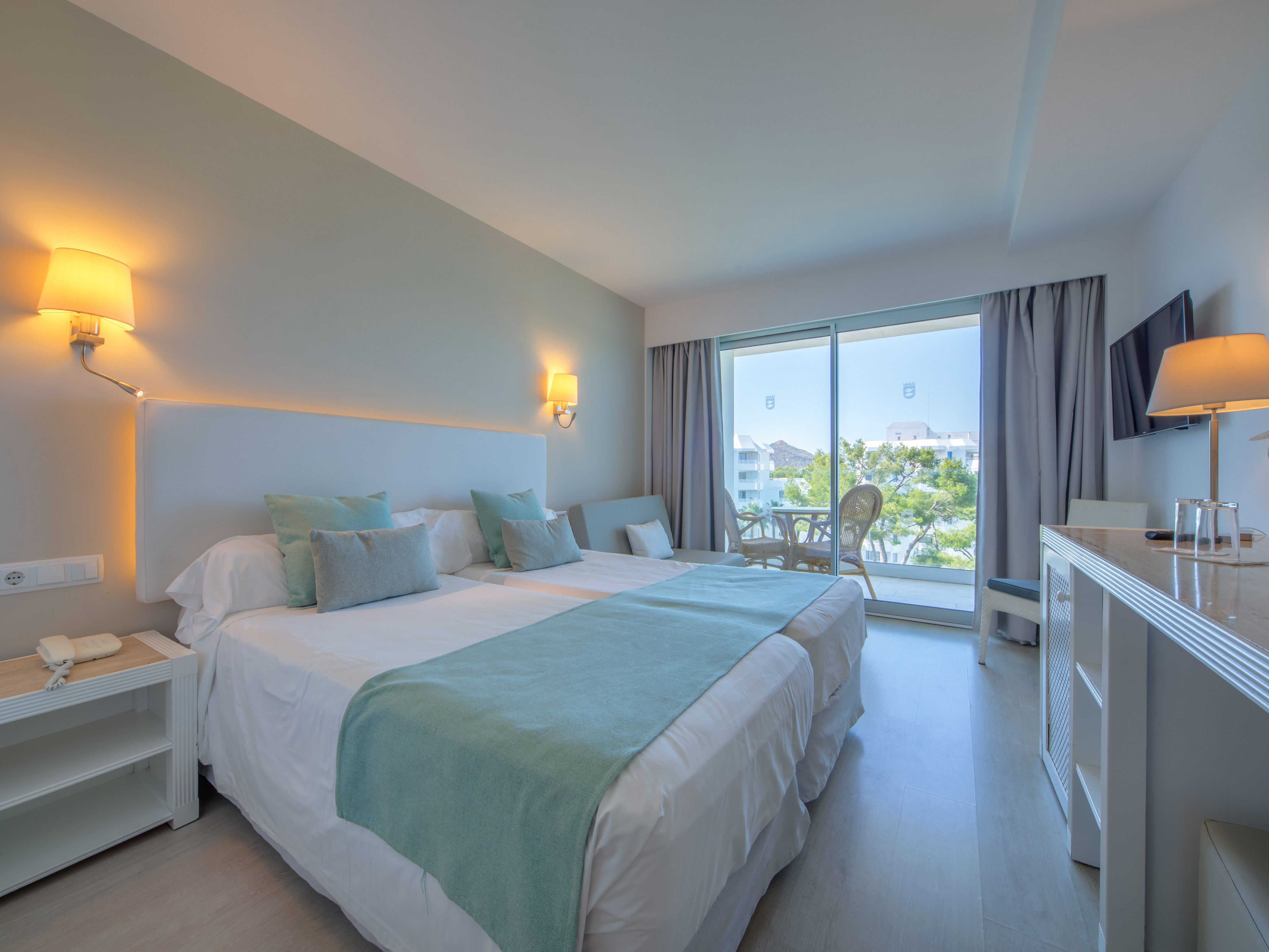 a bedroom with a large bed and a glass door