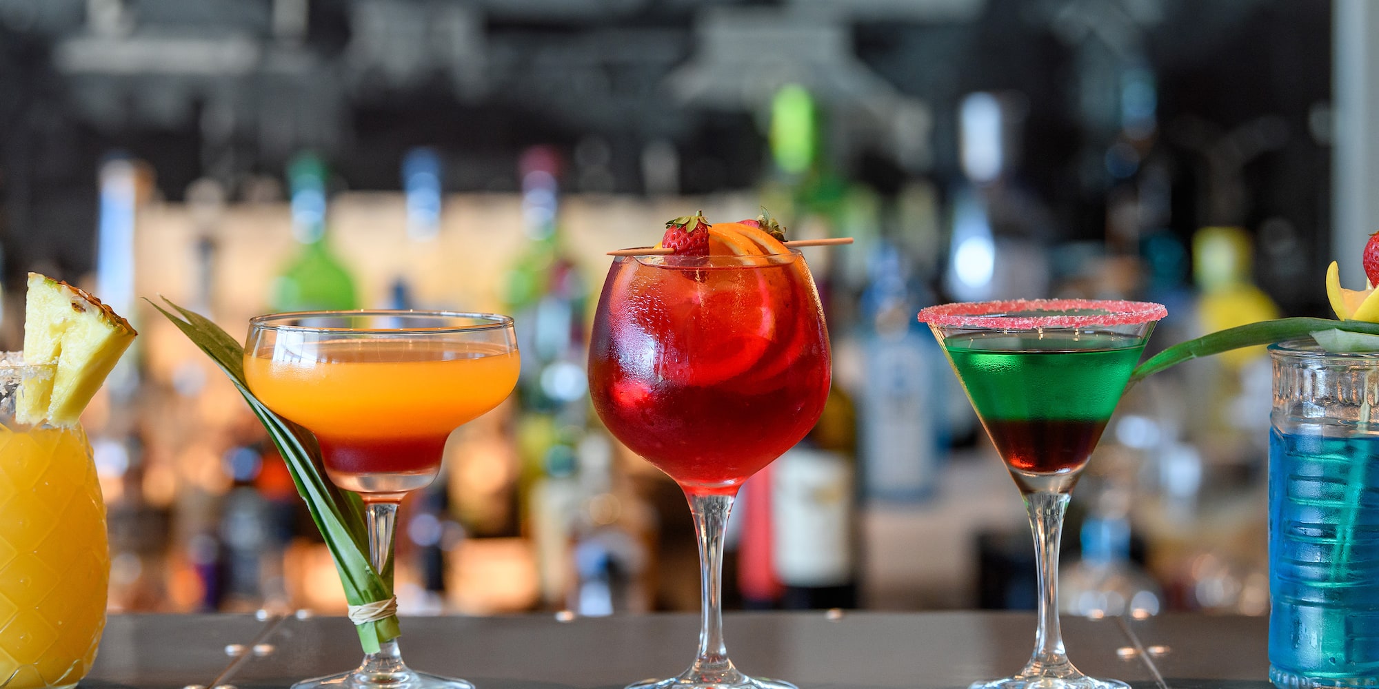 a group of drinks on a bar