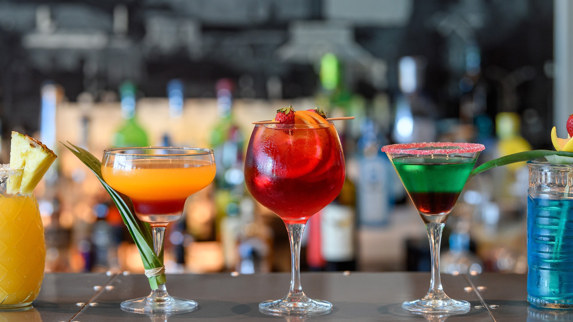 a group of drinks on a bar