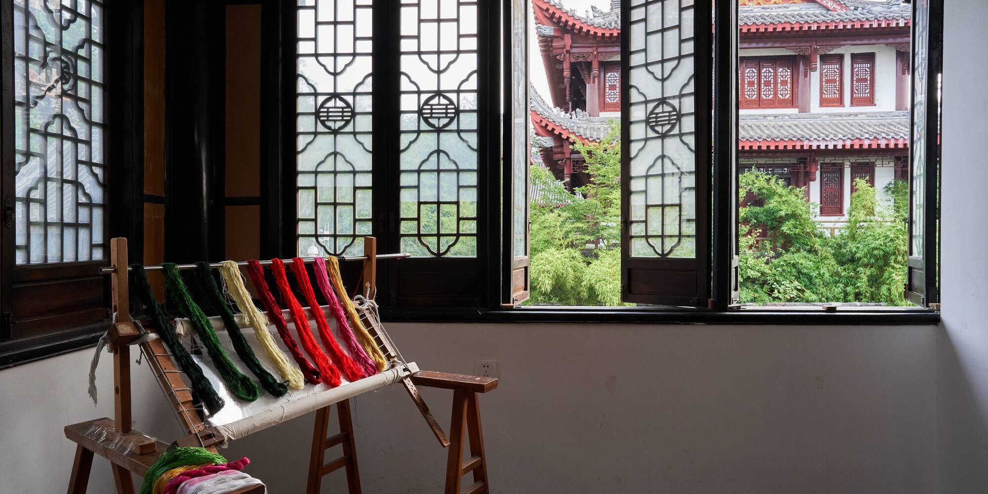 a loom with colorful yarn on it