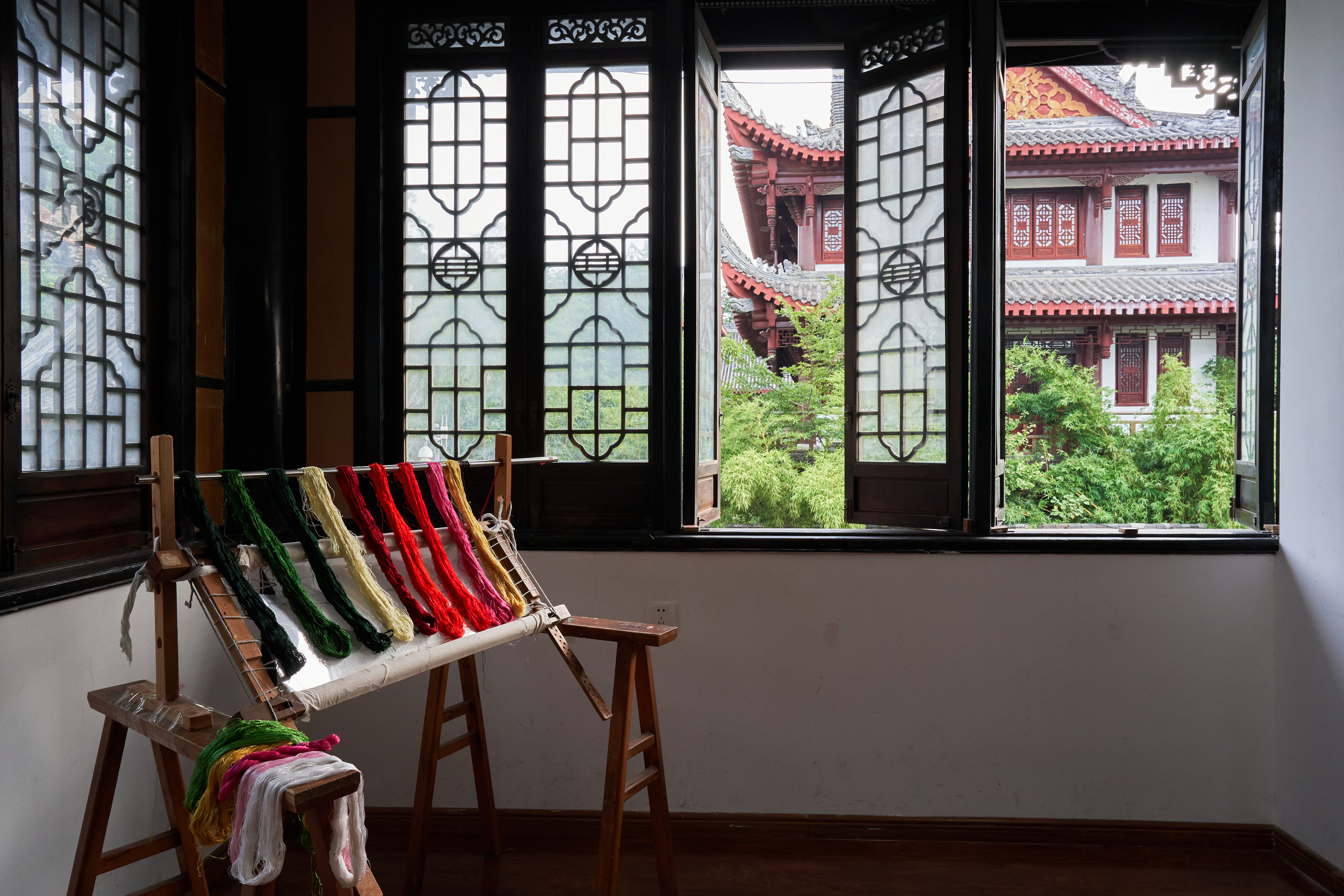 a loom with colorful yarn on it