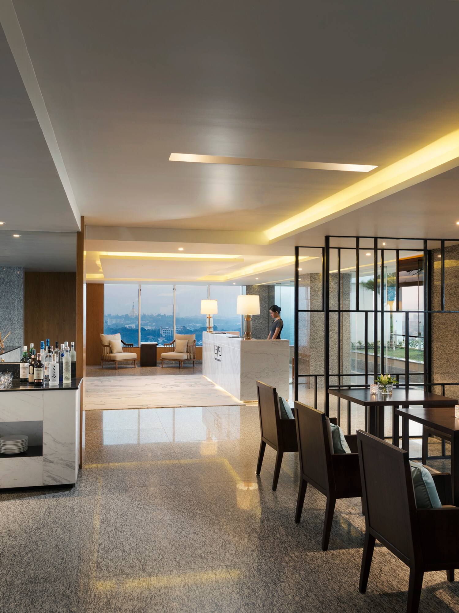 a room with a bar and chairs