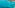 Turquoise sea with coastal town, ancient fortress, mountains, and rocky island.