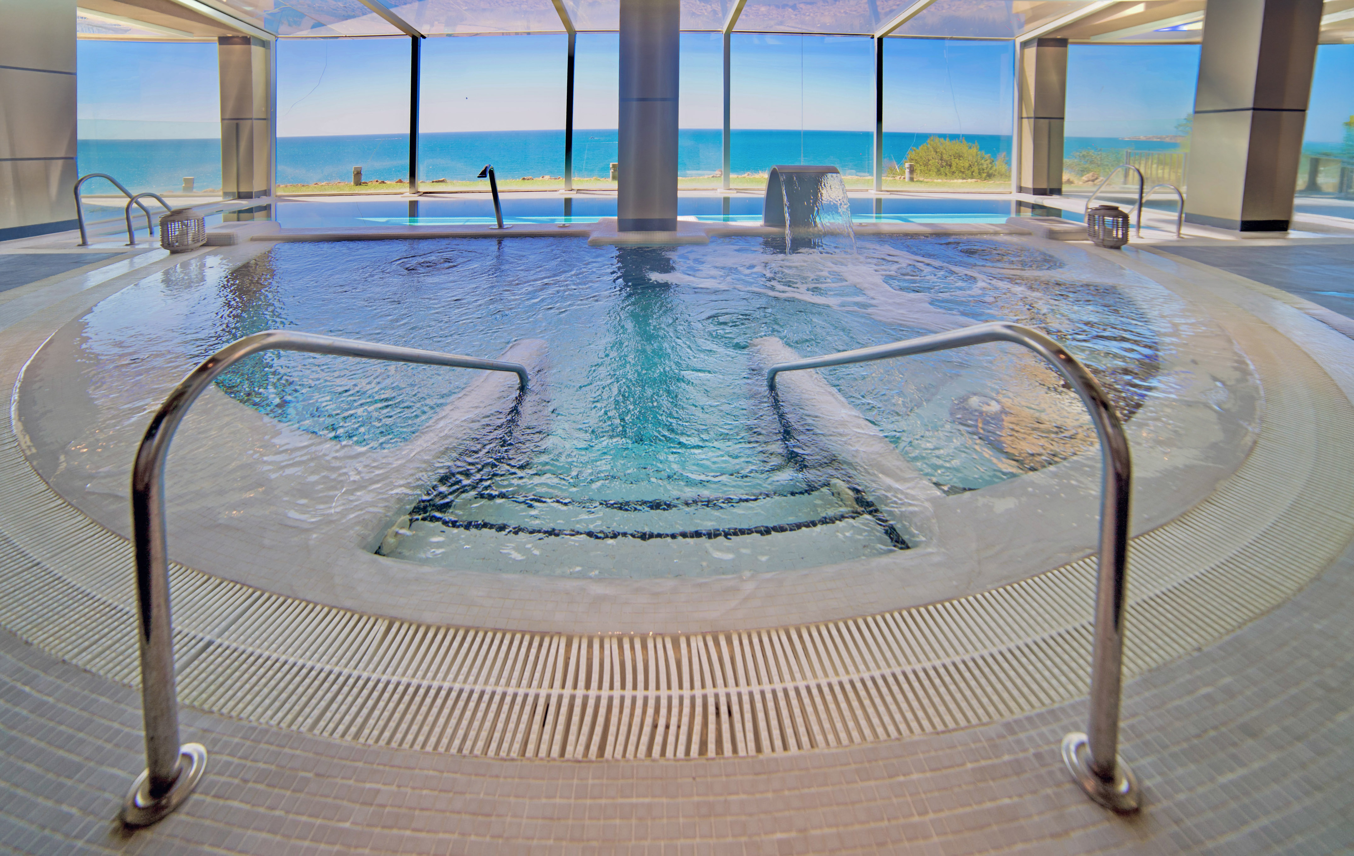 a large indoor pool with stairs and railings
