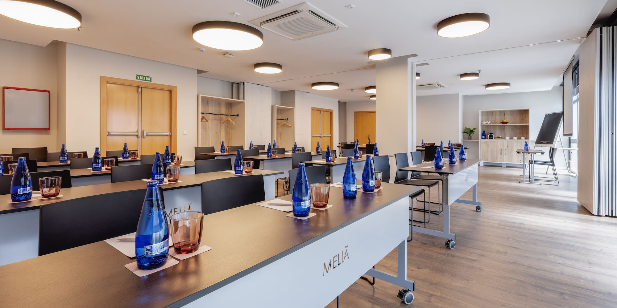 a room with tables and blue bottles