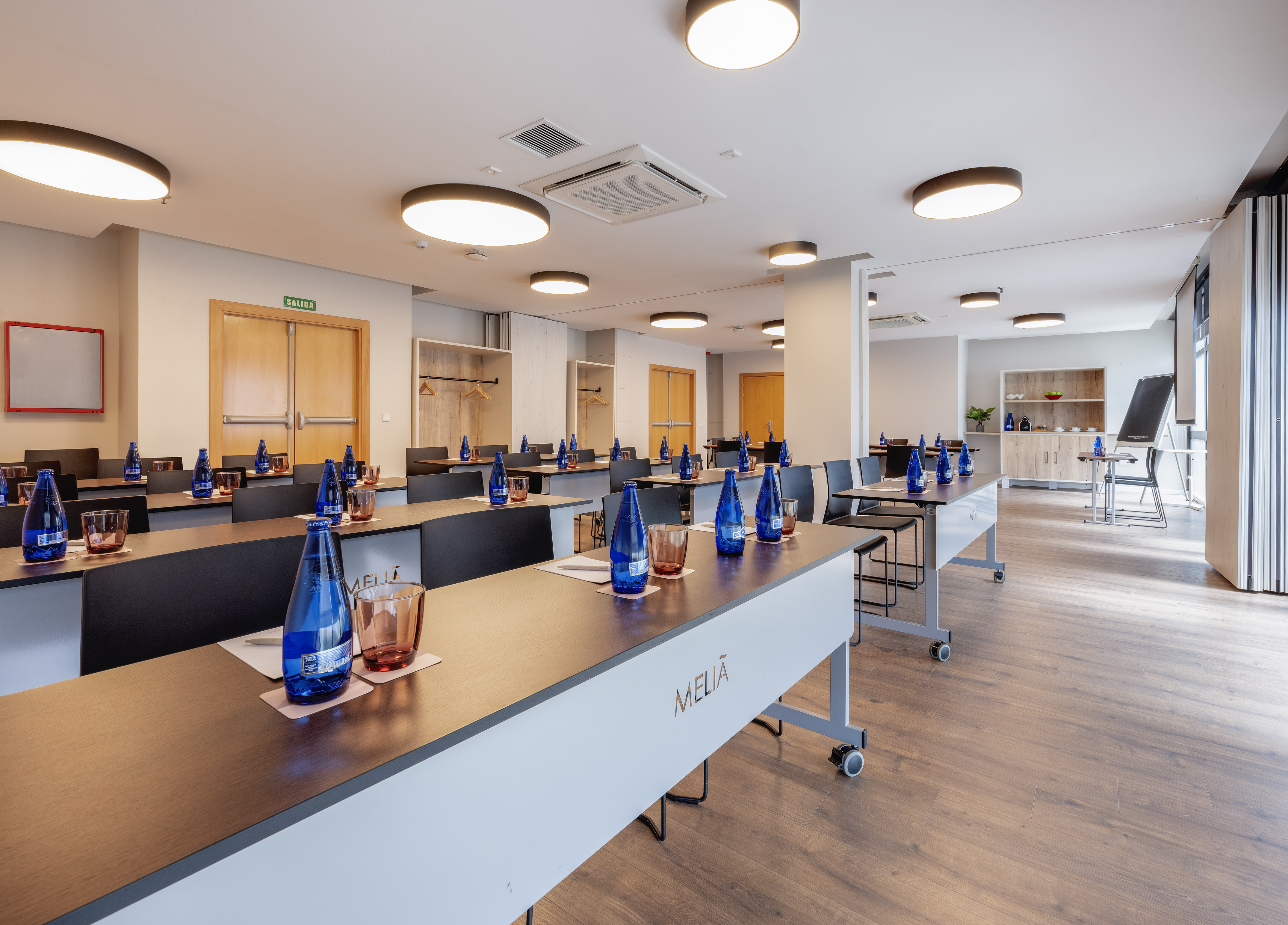 a room with tables and blue bottles