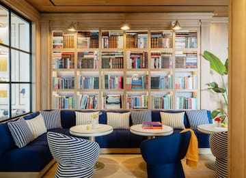 a room with a couch and bookshelf